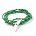 Macro detail of multicolored braided rope bracelet with a silver whale tail charm - SW-05 Green Yellow Black Mixed