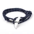 Blue braided rope bracelet with a silver metal whale tail clasp on a white background - SW-15 Blue White Spots
