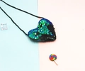 Detail of heart-shaped flip sequin coin purse for kids with adjustable black lanyard strap - Green and Matte Black