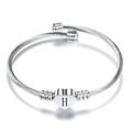 Macro detail of silver stainless steel heart pendant bracelet with engraved letter H - Letter H / Steel