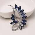 Dark blue crystal leaf brooch with silver base and clear rhinestones on beige surface - MM-BR-0491 White K (Leaf)