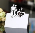 Close-up of laser-cut Mr & Mrs wedding place card with bride groom and rings detail - White