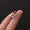 U-shaped silver ear cuff with sparkling cubic zirconia crystals shown on finger - 3# Cross