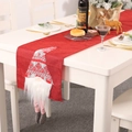 Red Christmas table runner with 3D Swedish gnome and striped legs on festive dinner table - Nordic Gnome / Red