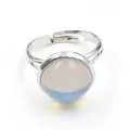 Close-up of adjustable silver ring with a round translucent cabochon stone inlay - Adjustable Open / Synthetic Opal