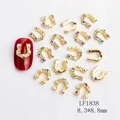 Golden horseshoe nail charms with rhinestones and U-shape design on deep red manicure - Gold AB Rhinestone U-shape Style (1838)