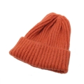 Close-up of caramel orange knit beanie showing detailed soft yarn texture and ribbing - One Size / Orange