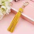 Elegant yellow faux leather tassel keychain with gold lobster clasp on gift box - Gold
