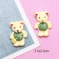 Macro shot of 1.5x2.2cm bear resin charms for DIY crafts and jewelry making - Yellow Bear in Green Clothes