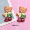 Detailed view of two cute resin bear charms measuring 1.8x2.6cm for DIY craft projects - Bear with Green Backpack