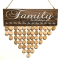 Macro detail of Family Birthdays wooden board with round hanging discs for home decor - Family Birthdays