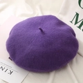 Close-up of deep purple wool beret hat on white fabric with books for a stylish look - One Size / Light Purple