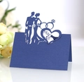 Macro detail of laser-cut navy blue wedding place card with Mr & Mrs silhouette - Sapphire Blue