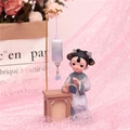 Retro resin figure of a lady reading at a desk with a lantern in soft purple tones - 1060-5 Reading Style