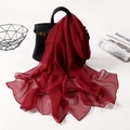 Deep red solid color long chiffon scarf draped elegantly over a black leather handbag - Dark Red