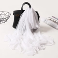 Elegant white chiffon scarf draped over a black bag with a soft flowing texture - Pure White