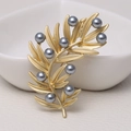 Elegant matte gold branch brooch featuring grey pearl accents on a neutral surface - 0486-Gold Branch Pearl