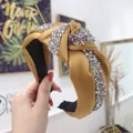 Mustard yellow knotted headband featuring hand-set crystals on satin fabric texture - Yellow