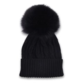 Close-up of black cable-knit beanie with a large matching faux fur pom-pom detail - Black