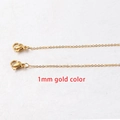 Macro shot of 1mm gold-plated stainless steel square link chain with lobster clasp detail - 1mm Gold Color