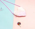 Detail of heart-shaped sequin crossbody bag for kids with pink zipper and gradient finish - Pink + White