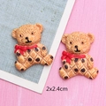 Detail view of brown resin cartoon bears with polka dots and red bows for DIY crafts - Light Coffee Bear with Red Scarf