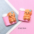 Close-up of 2.3cm resin cartoon bear charms for DIY hair clips and jewelry making - Pink Cup Bear