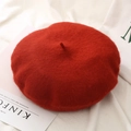 Detailed texture of red wool beret pumpkin hat on aesthetic white fabric background - One Size / Caramel color