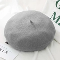 Close-up of grey knitted wool beret showing soft texture and fine stitching detail - One Size / Light Gray