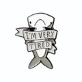 Cartoon shark enamel brooch with I'M VERY TIRED ribbon message in grey and white - I'M VERY TIRED Shark