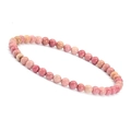 Detailed view of 4mm pink natural stone beads on a stretch bracelet with stone texture - Rhodonite