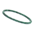 Detailed close-up of 4mm natural green malachite beads with unique banded textures - Malachite