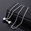 Silver dumbbell pendant necklace with box chain resting on a sleek black box display - Dumbbell Pendant