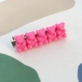 Detailed macro shot of five hot pink resin jelly bears on a silver metal hair clip - Plum Pink