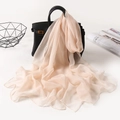 Elegant apricot chiffon scarf draped on a handbag with premium soft aesthetic display - Nude