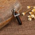 Tiger eye hexagonal crystal bullet pendant necklace with silver metal clasp on wood - Tiger Eye
