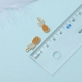 Detail of yellow pineapple alloy pendants with gold trim for DIY jewelry making - Pineapple