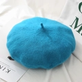 Close-up of wool blend lake blue beret with soft texture and decorative top stem - One Size / Lake Blue
