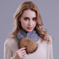 Detail of purple knitted snood featuring a large fluffy faux fur pom-pom on white sweater - Navy Blue