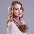 Close-up of pink knitted snood scarf featuring a fluffy faux fur pom-pom detail - Burgundy