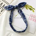 Detail of navy blue paisley cotton headband with rabbit ears on textured fabric - Dark Blue