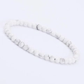Detailed macro view of 4mm white turquoise stone beads with marble texture for a bracelet - Howlite
