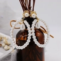 Detail of vintage gold earrings with pearls and crystals hanging on a brown glass bottle - Style 7 Stud (925 Silver Post)