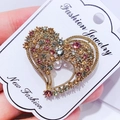 Golden heart brooch with colorful rhinestones and intricate hollow design on display card - G2 Heart