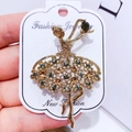 Golden ballet dancer brooch with emerald and amber rhinestones on a display card - G1 Ballerina Girl