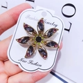 Elegant gold flower brooch with purple and grey crystals on a fashion display card - G10 Flower Style 03
