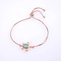 Detail of rose gold turtle bracelet with green opal inlay and adjustable slider chain - Green Double Turtle / Rose Gold