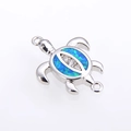 Silver turtle connector with blue opal inlay and sparkling zircons on white background - White Gold Plated Blue Opal Turtle (Connector)