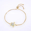 Detailed macro view of a gold-plated turtle charm bracelet with blue opal and zircons - Gold Plated Pink Opal Turtle Bracelet