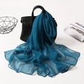 Elegant peacock blue translucent long chiffon scarf draped over a black leather handbag - Peacock Blue